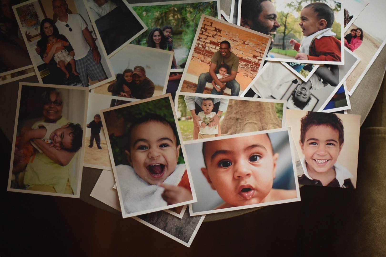 Printed photos of a little boy over the years