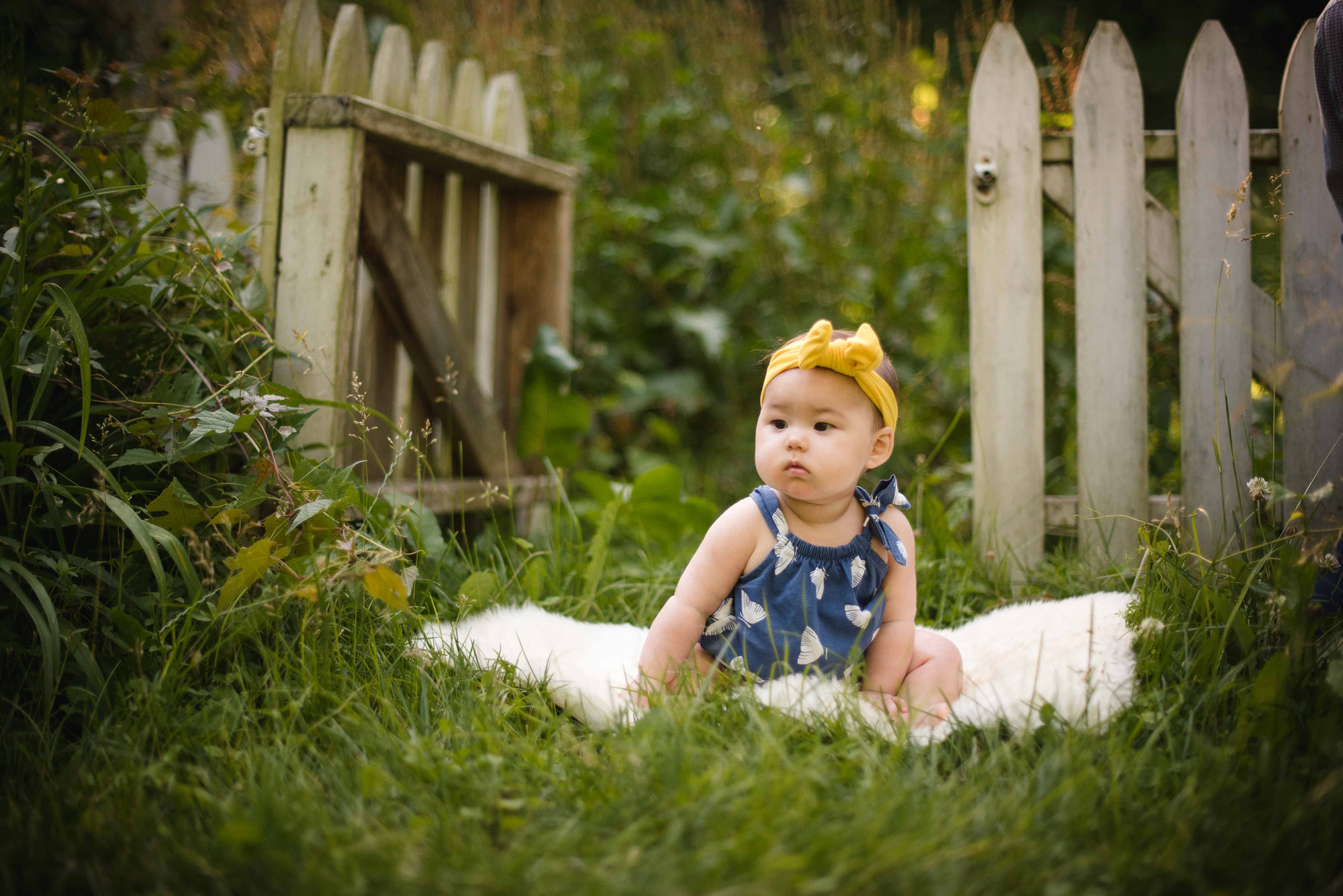 6 month old girl sitting up in garden in Wissahickon Creek park