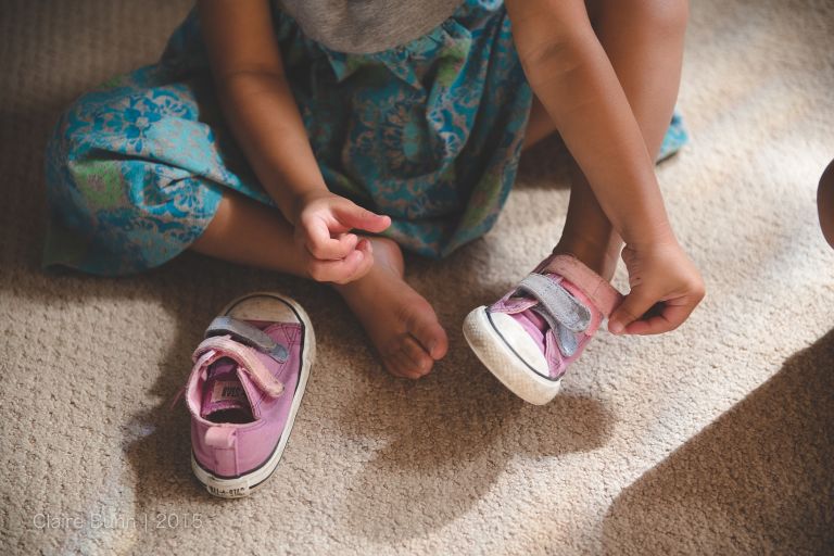 Toddler putting on shoes