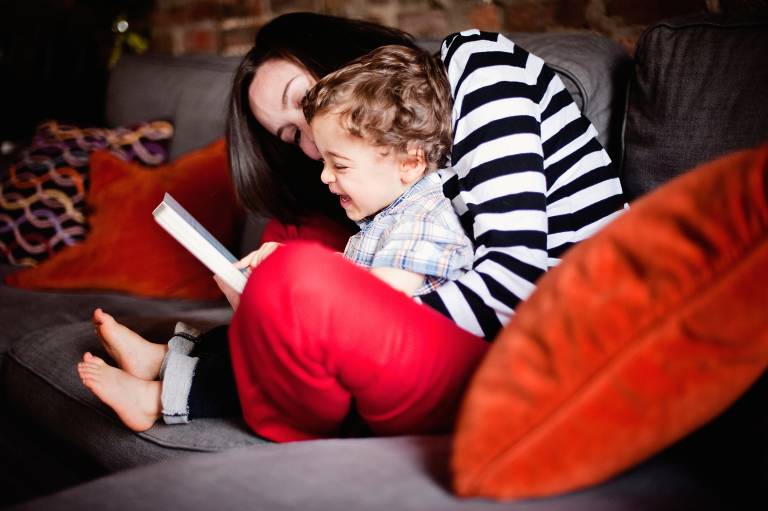 Mother and son reading on couch