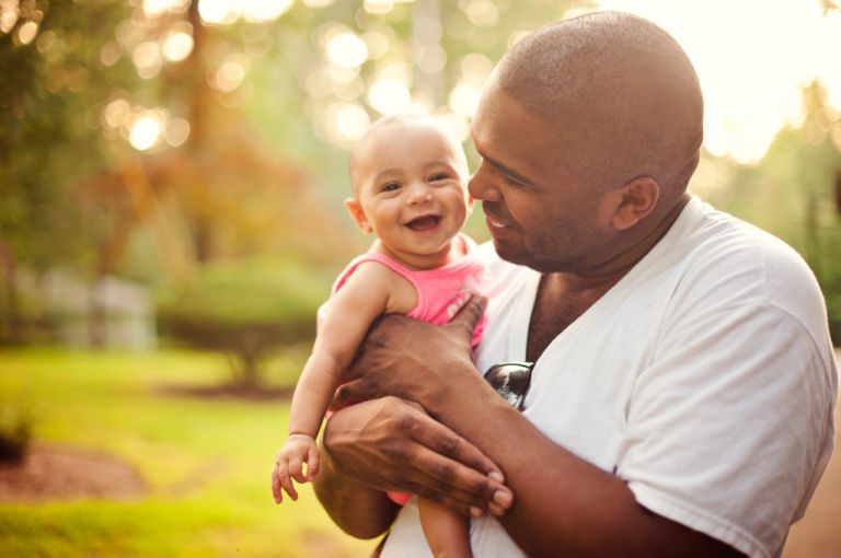 6 month old girl smiling with her uncle