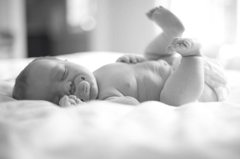 Baby sleeping with feet in air