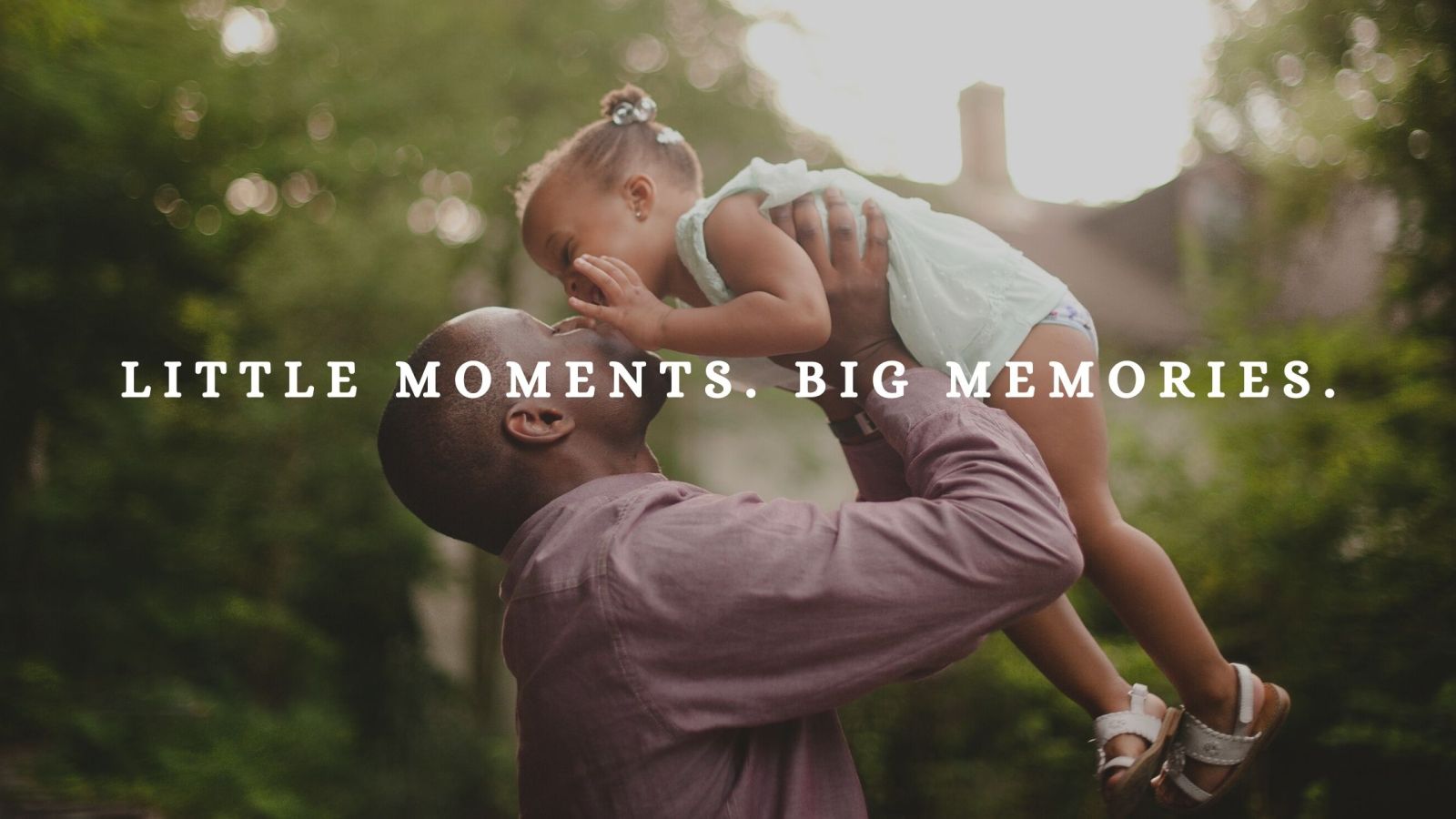 Father lifting giggling daughter in the air