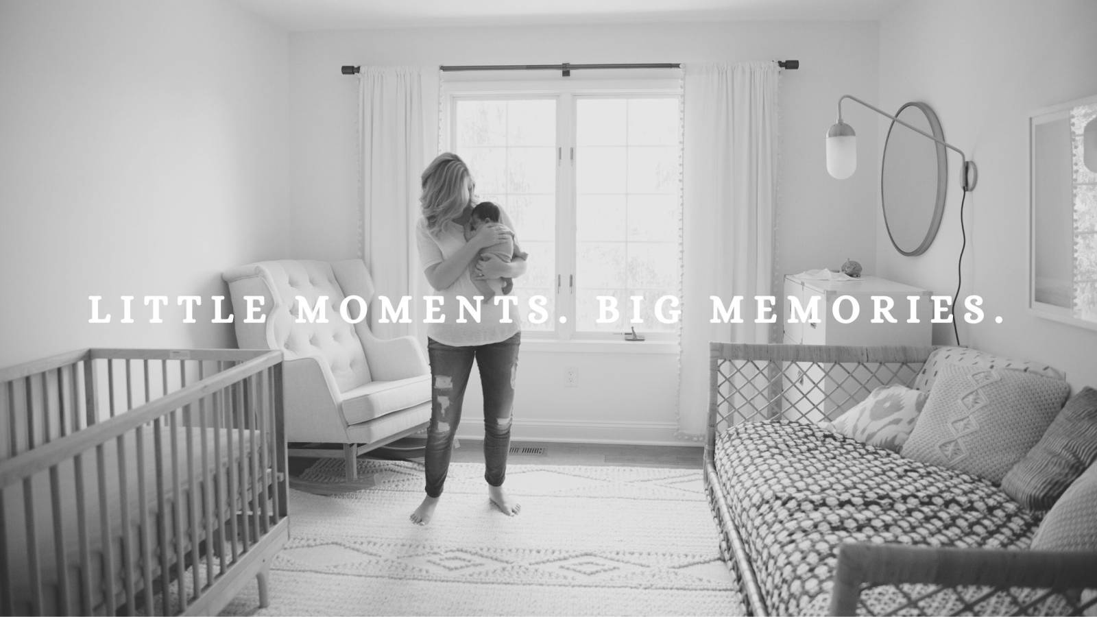 Mother holding newborn baby in nursery