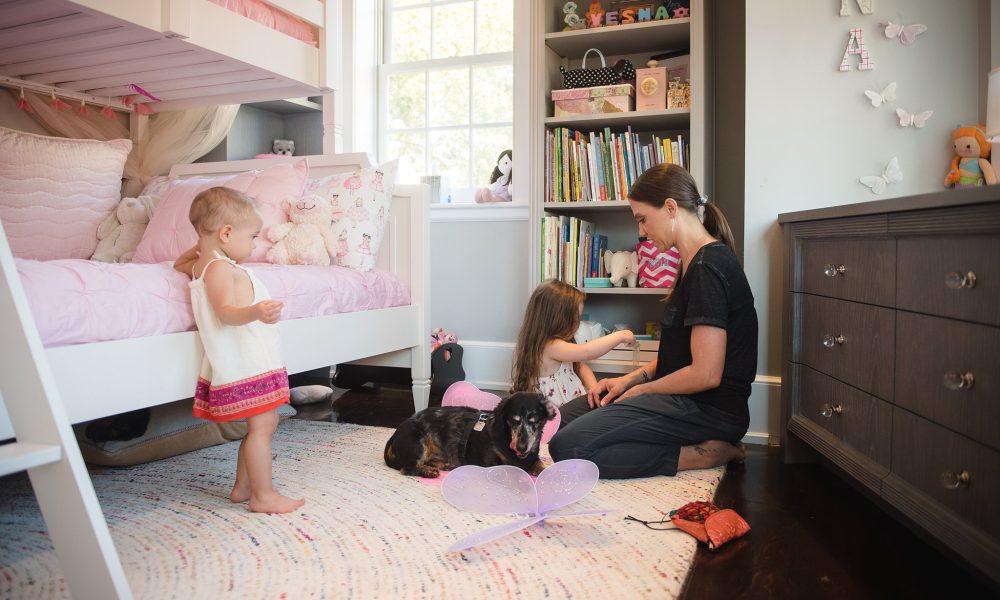 Mother and daughters in child's room