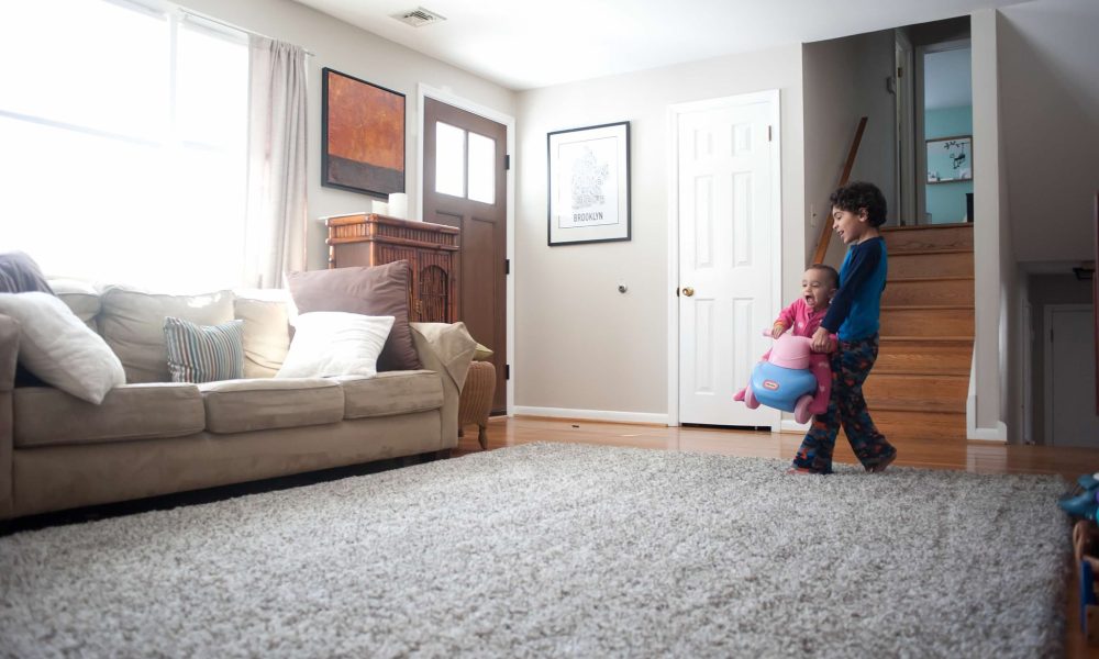 Siblings playing in living room